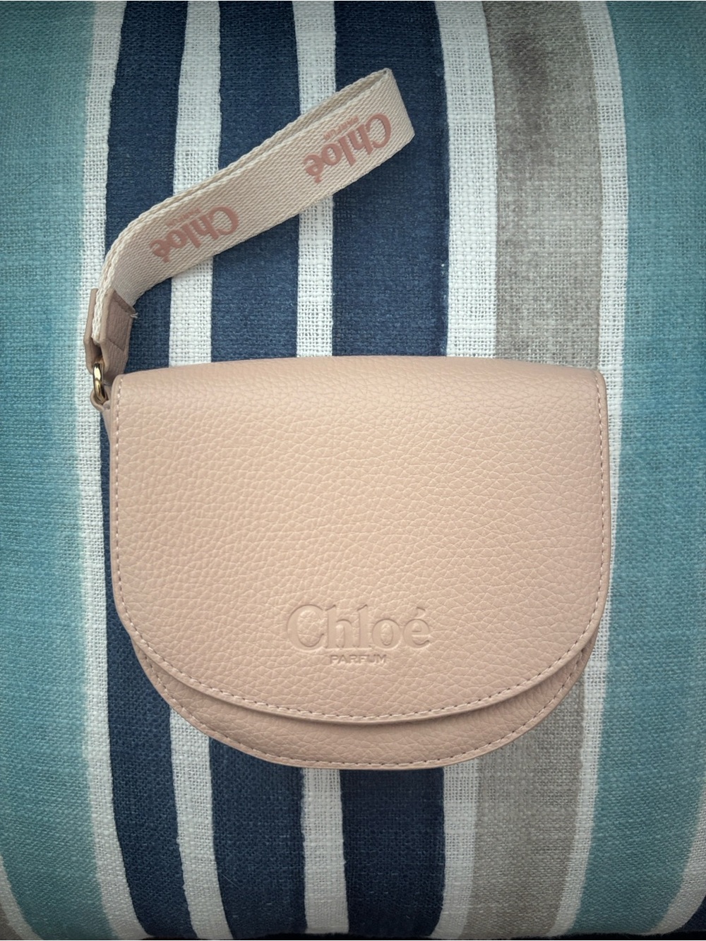 CHLOE BRAND Blush colored Pebbled Vegan Leather Parfum wristlet.